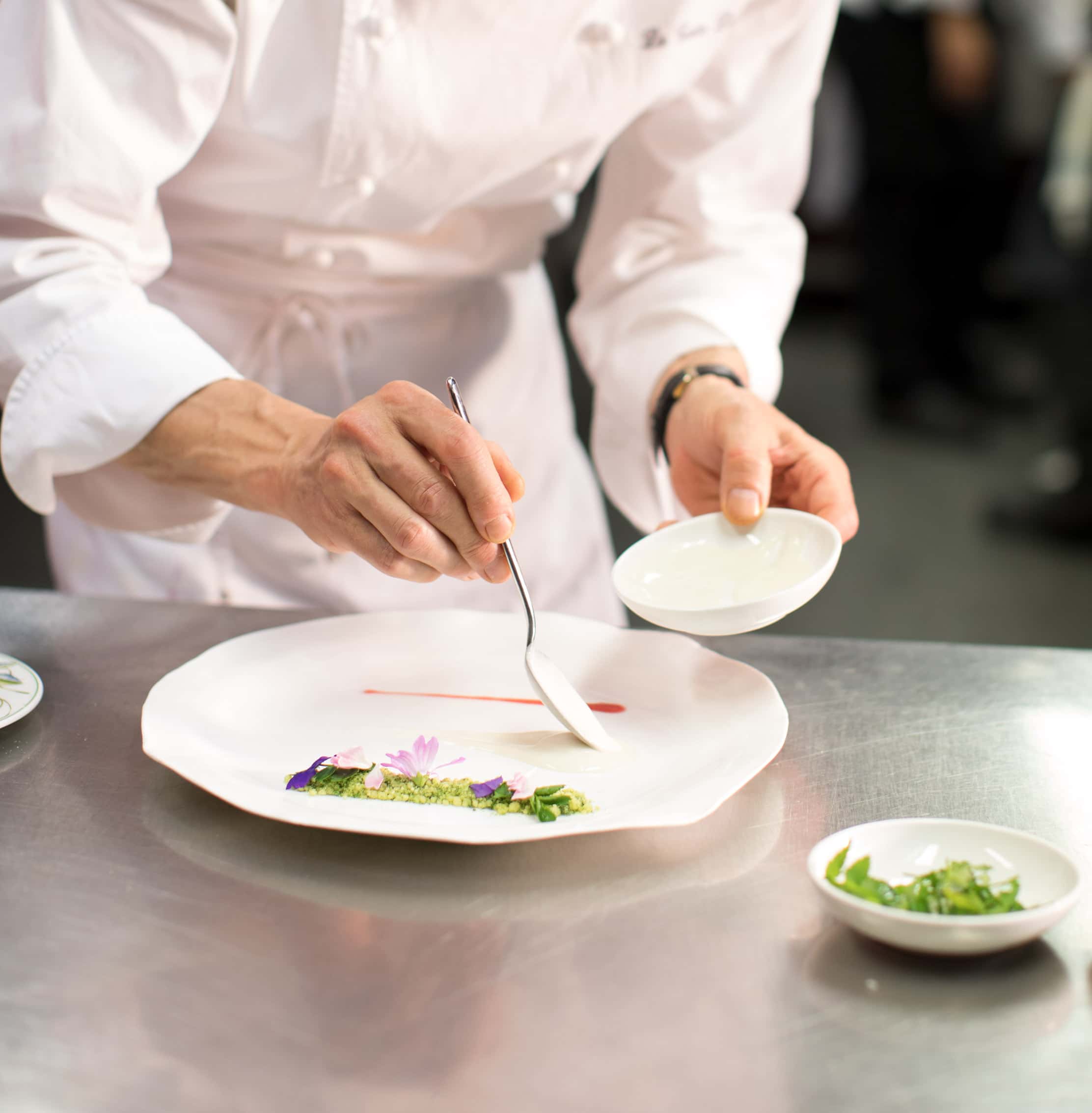 A Chef artfully plating a gourmet dish