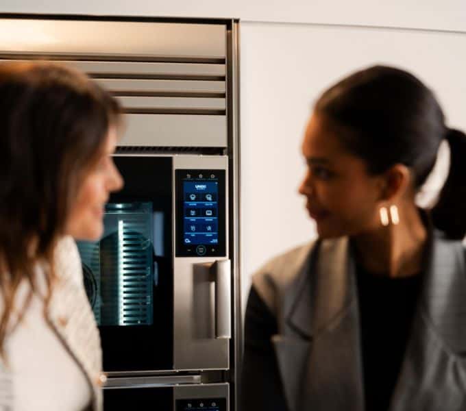 Women in front of SuperOven Model 1S